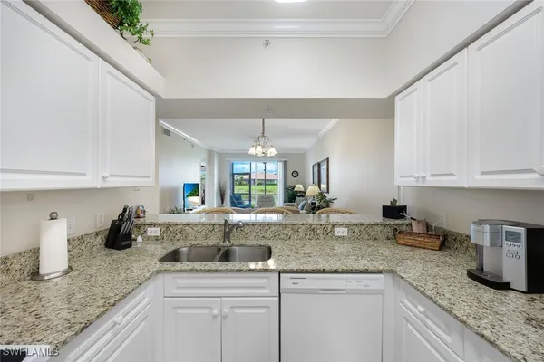 a kitchen with sink cabinets and window