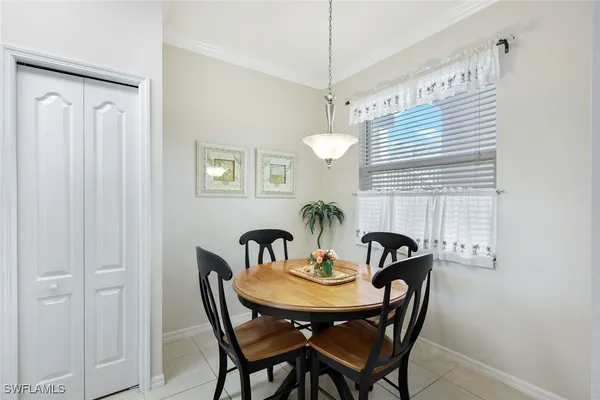 a view of a dining room with furniture and window