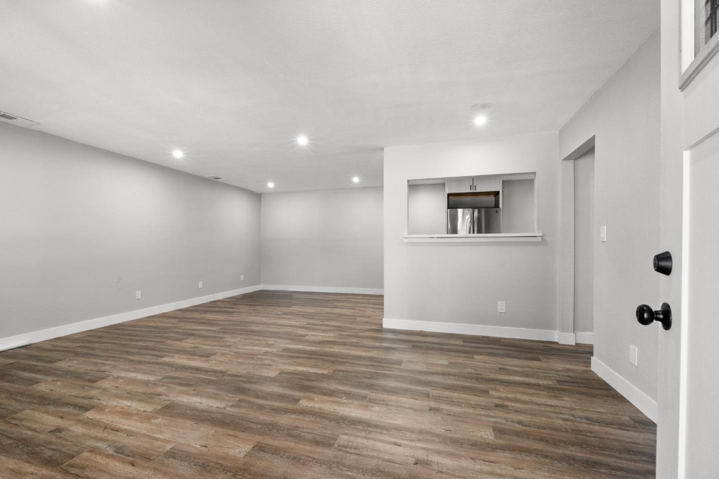 212 East Longview Avenue Stockton, CA 95207 - Photo 15 of 34 a view of an empty room with wooden floor and windows