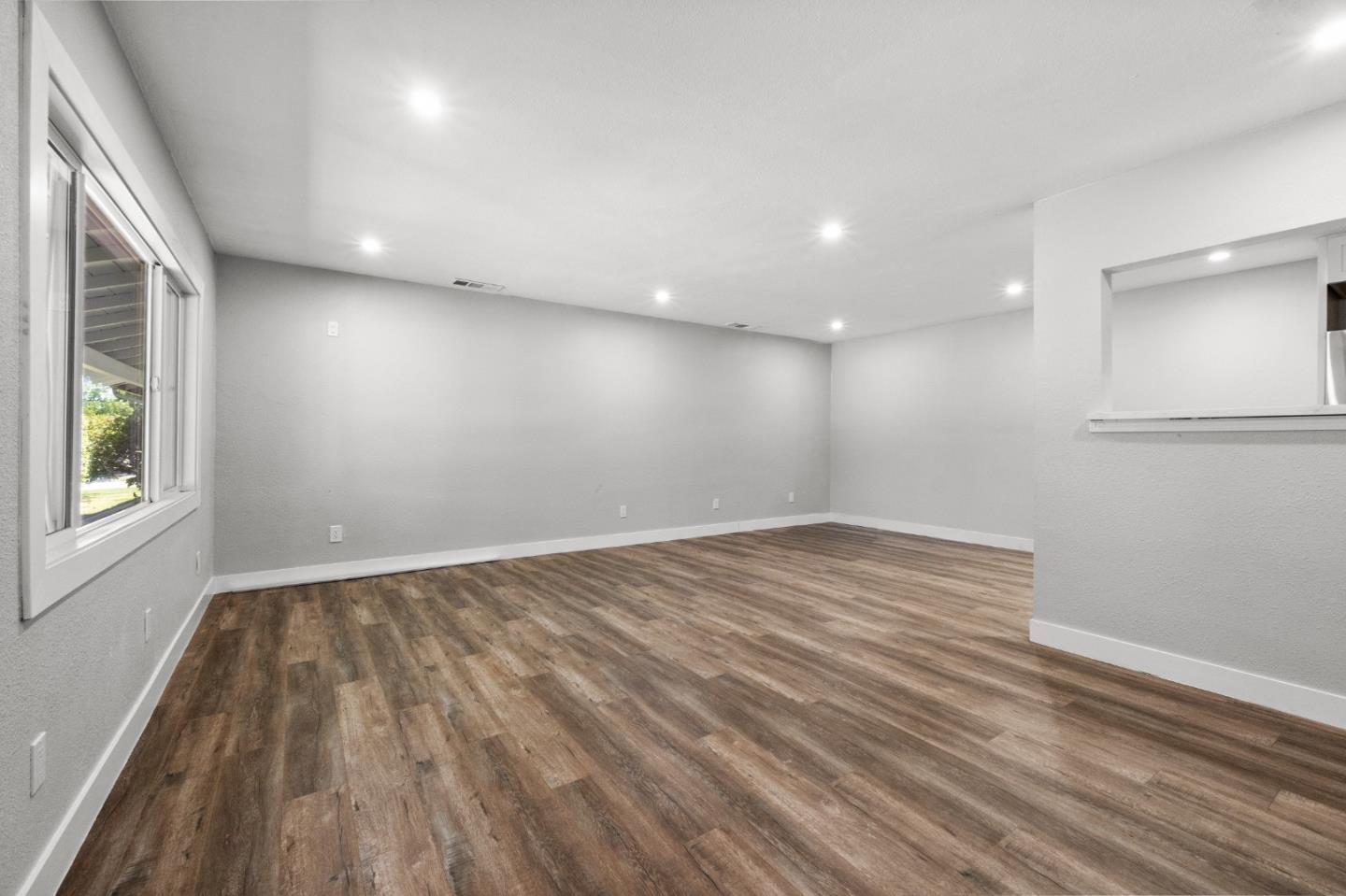 212 East Longview Avenue Stockton, CA 95207 - Photo 16 of 34 an empty room with wooden floor and windows