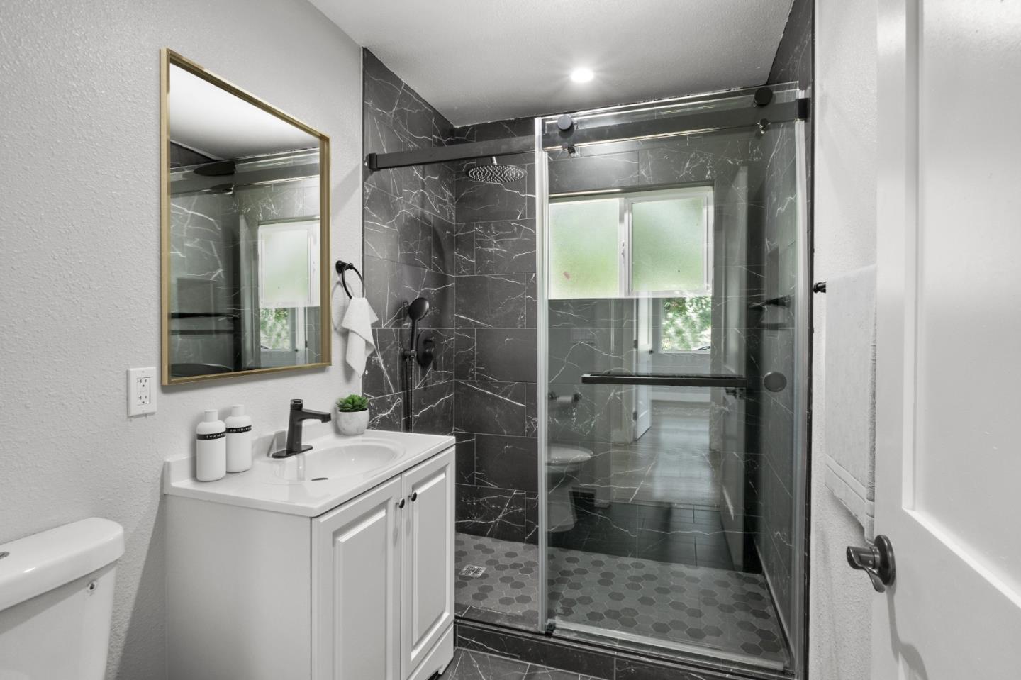 212 East Longview Avenue Stockton, CA 95207 - Photo 19 of 34 a bathroom with a shower sink and mirror