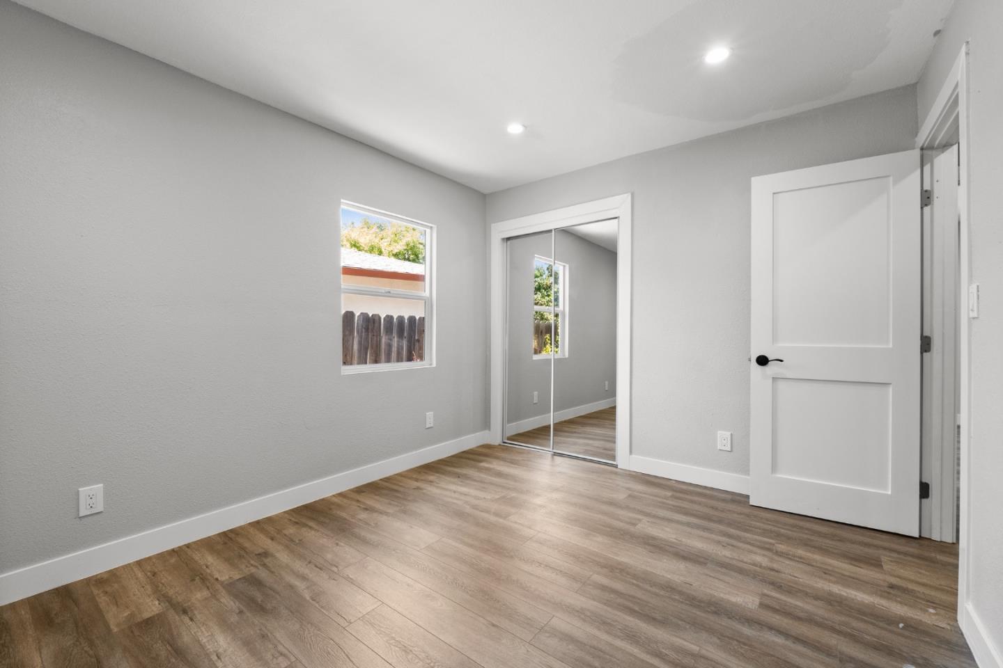 212 East Longview Avenue Stockton, CA 95207 - Photo 22 of 34 an empty room with wooden floor and windows