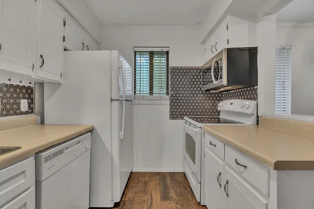 a view of an empty room and wooden floor