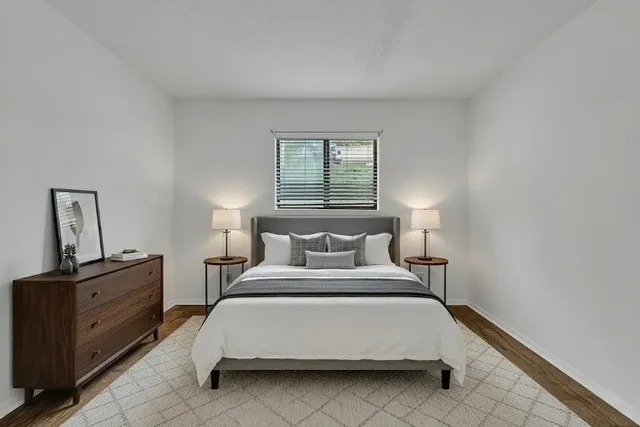 a bedroom with a bed and window