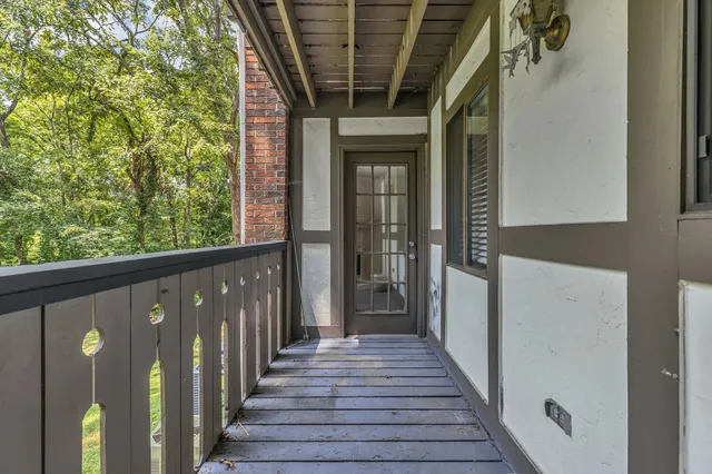 a view of a porch with wooden floor and outdoor space
