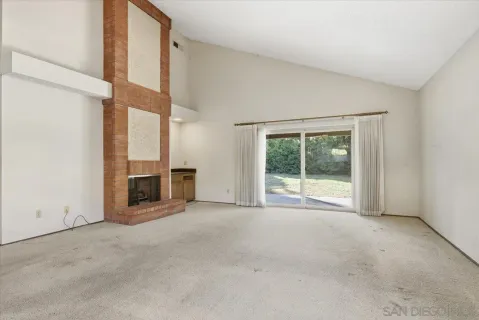 a view of a room with wooden floor and windows