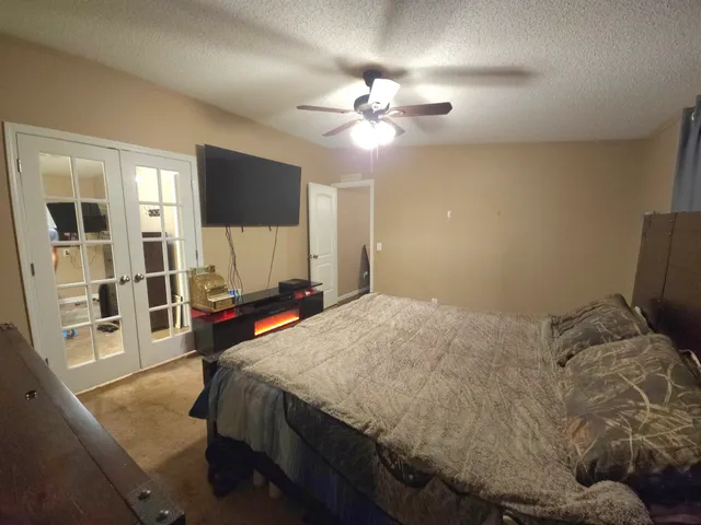 a bedroom with a bed and a flat screen tv