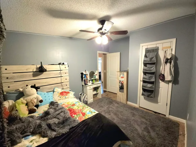 a bed room with a bed and a chandelier