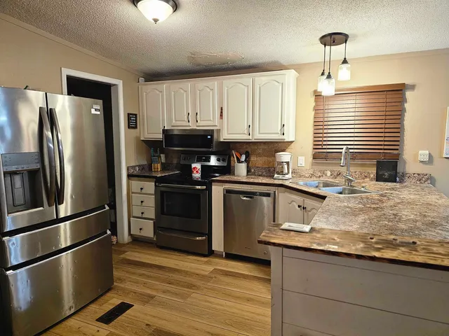a kitchen with a refrigerator and a sink