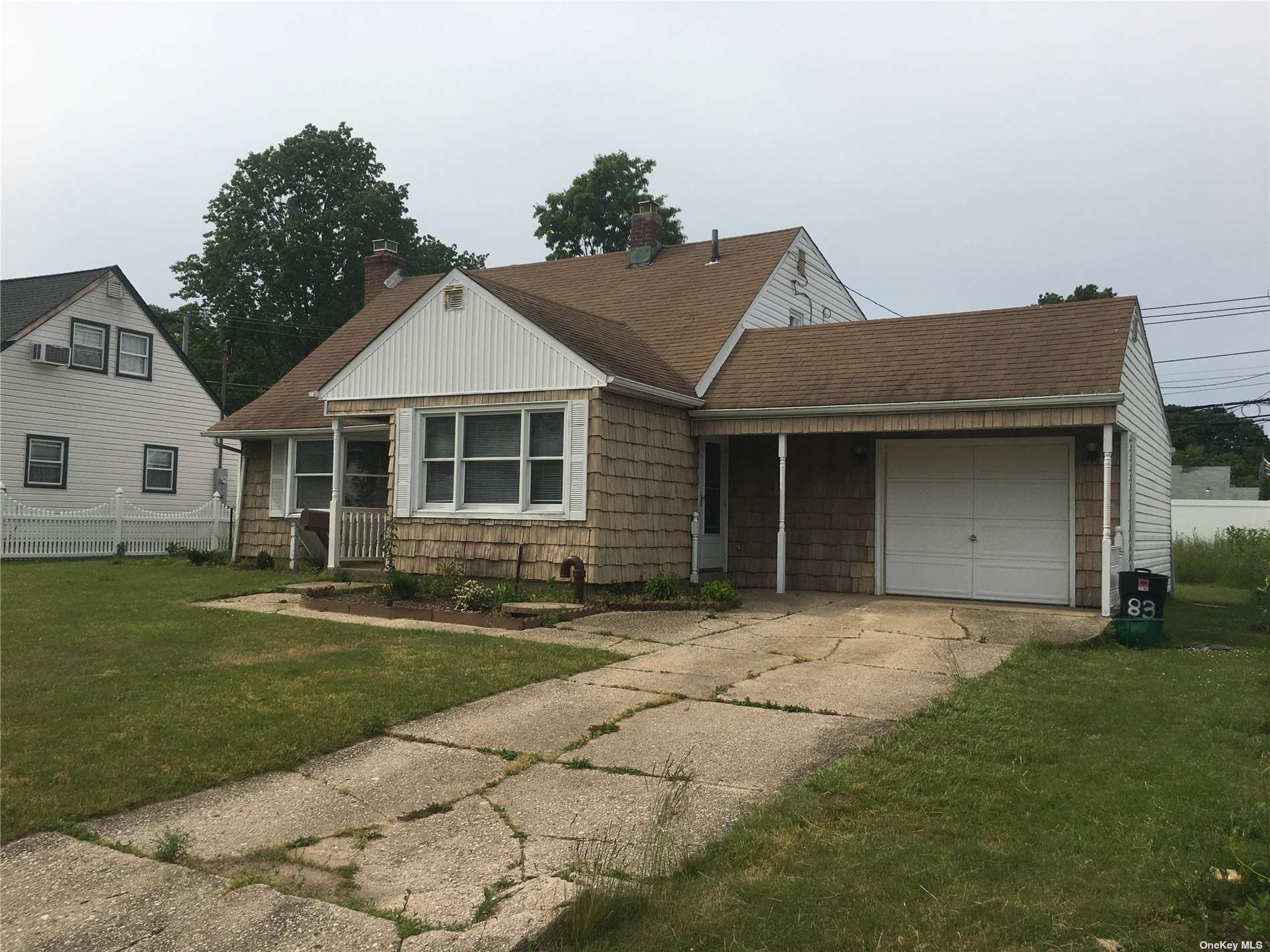 83 Periwinkle Road Levittown, NY 11756 - Photo 1 of 1 a front view of a house with a garden and yard