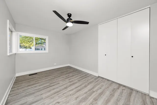 a view of a room with wooden floor and window