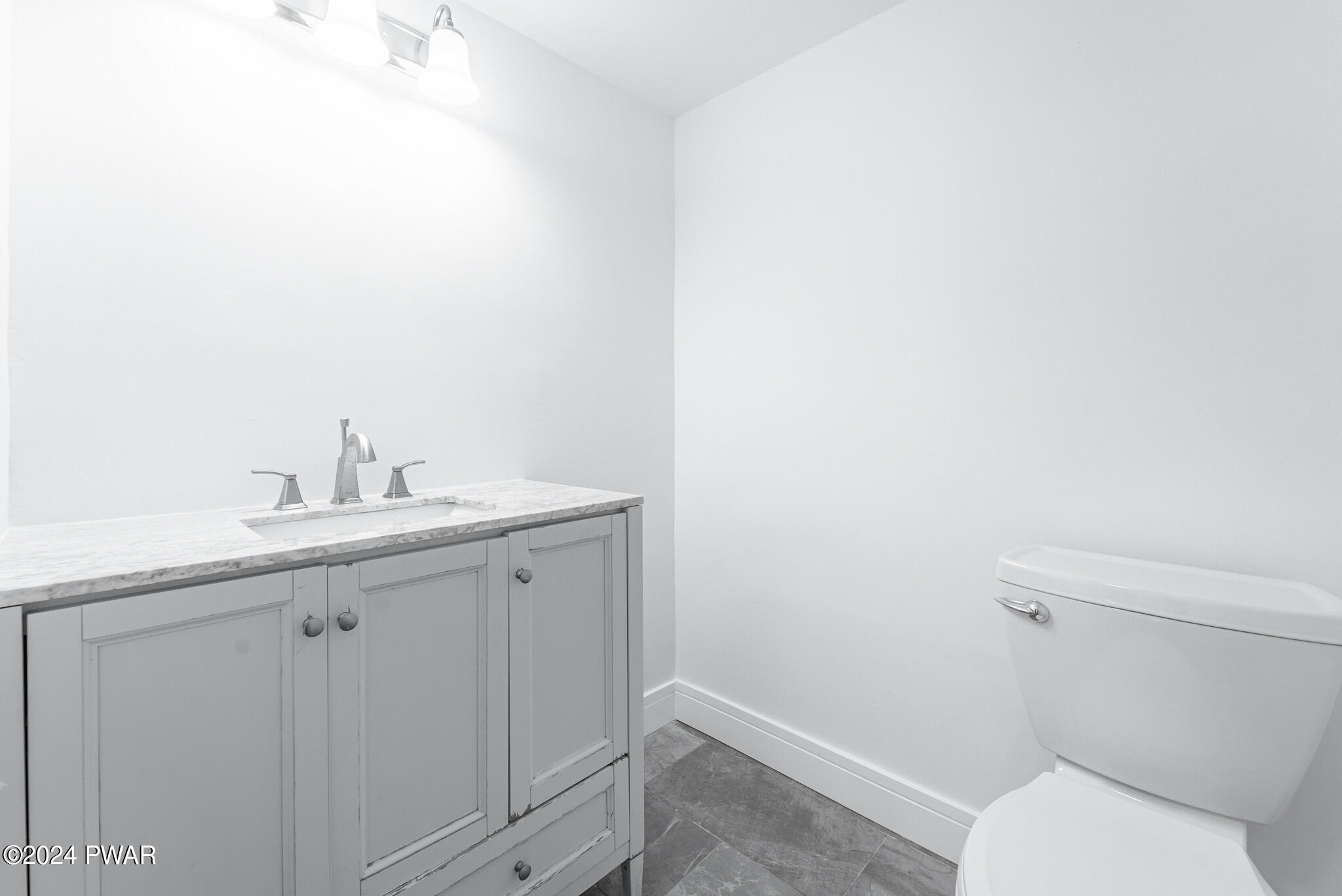 144 Log Tavern Road Milford, PA 18337 - Photo 45 of 45 a bathroom with a sink toilet and vanity