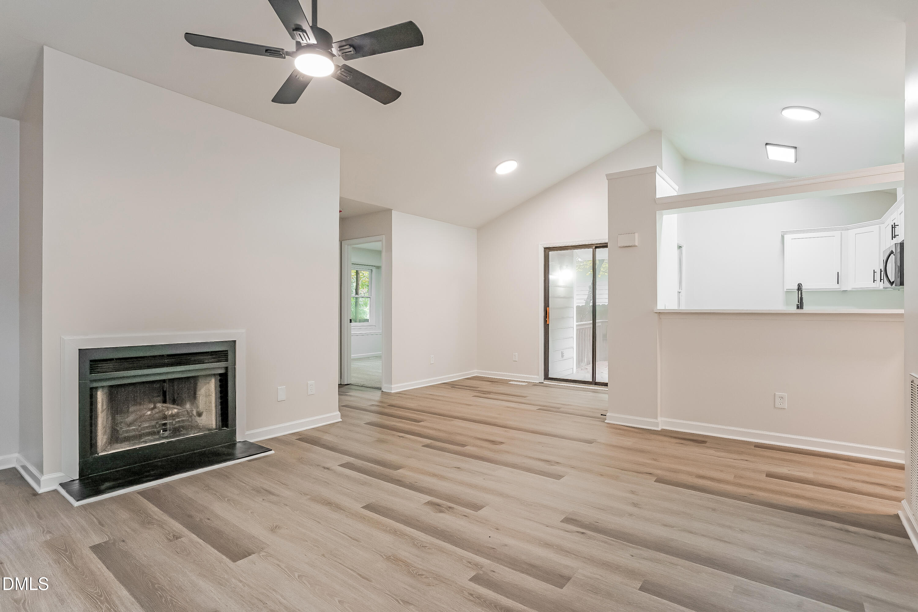 105 Stonelake Court Raleigh, NC 27610 - Photo 2 of 15 a view of empty room with kitchen and fireplace