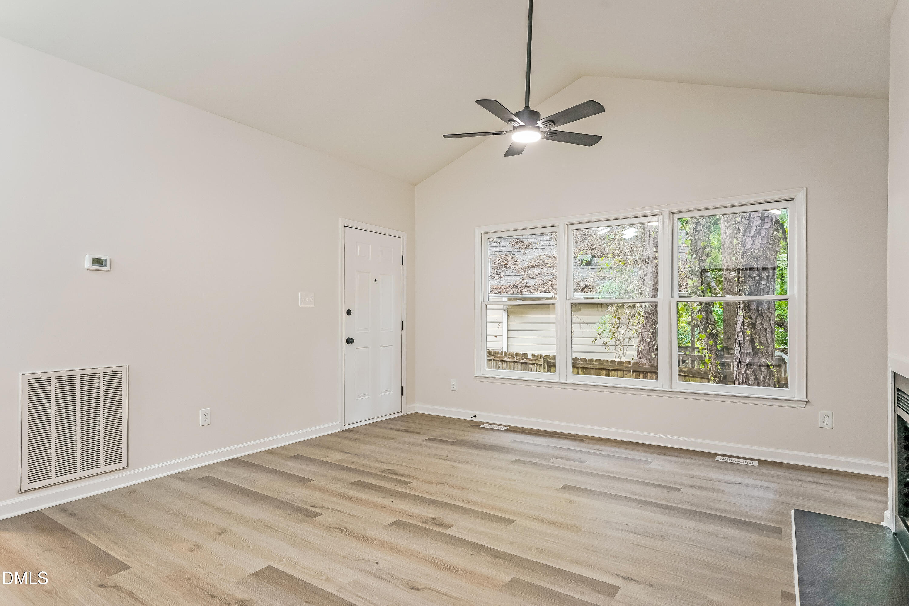 105 Stonelake Court Raleigh, NC 27610 - Photo 3 of 15 a view of an empty room with a window and wooden floor