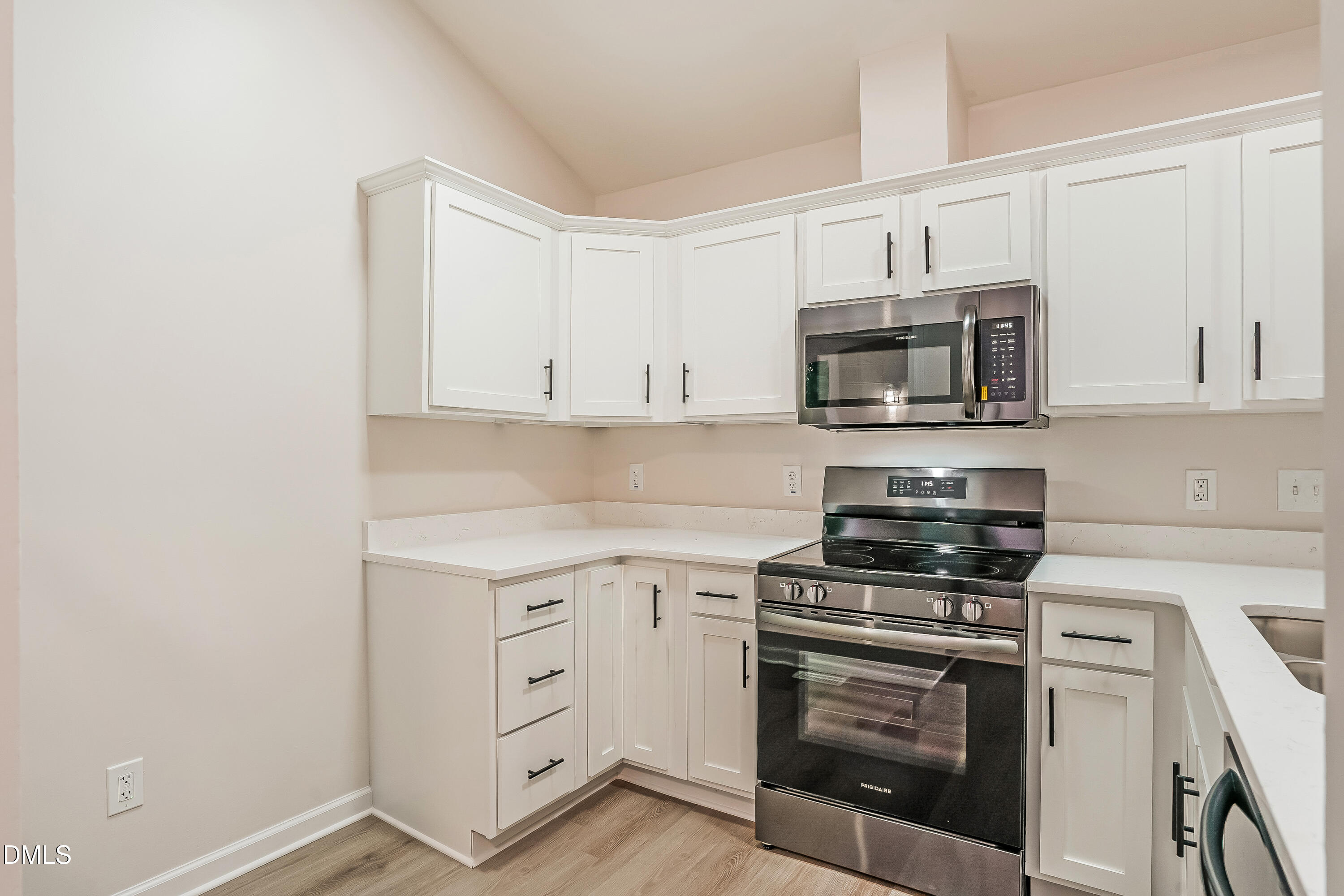105 Stonelake Court Raleigh, NC 27610 - Photo 5 of 15 a kitchen with white cabinets and stainless steel appliances