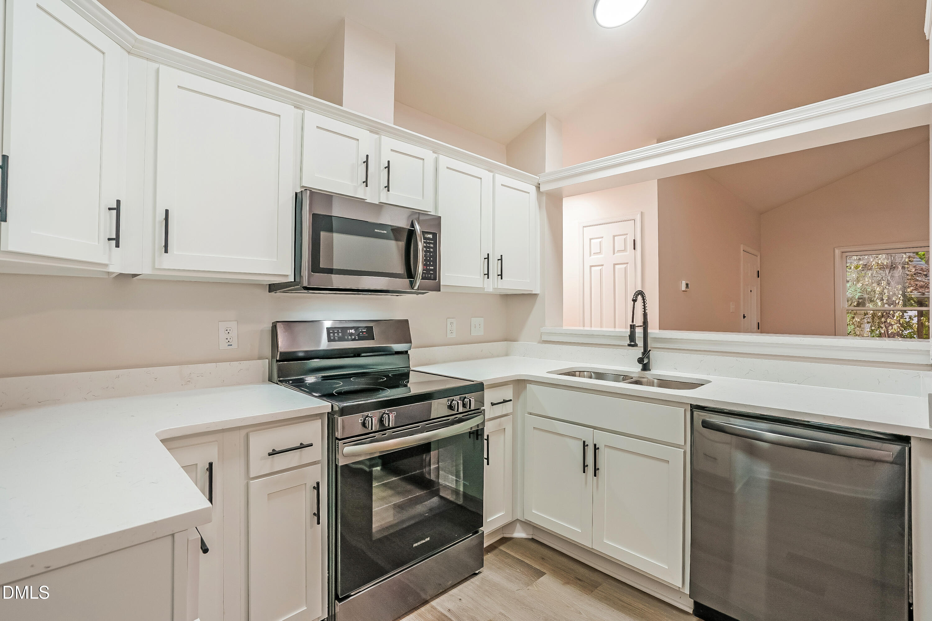 105 Stonelake Court Raleigh, NC 27610 - Photo 6 of 15 a kitchen with granite countertop white cabinets and white appliances