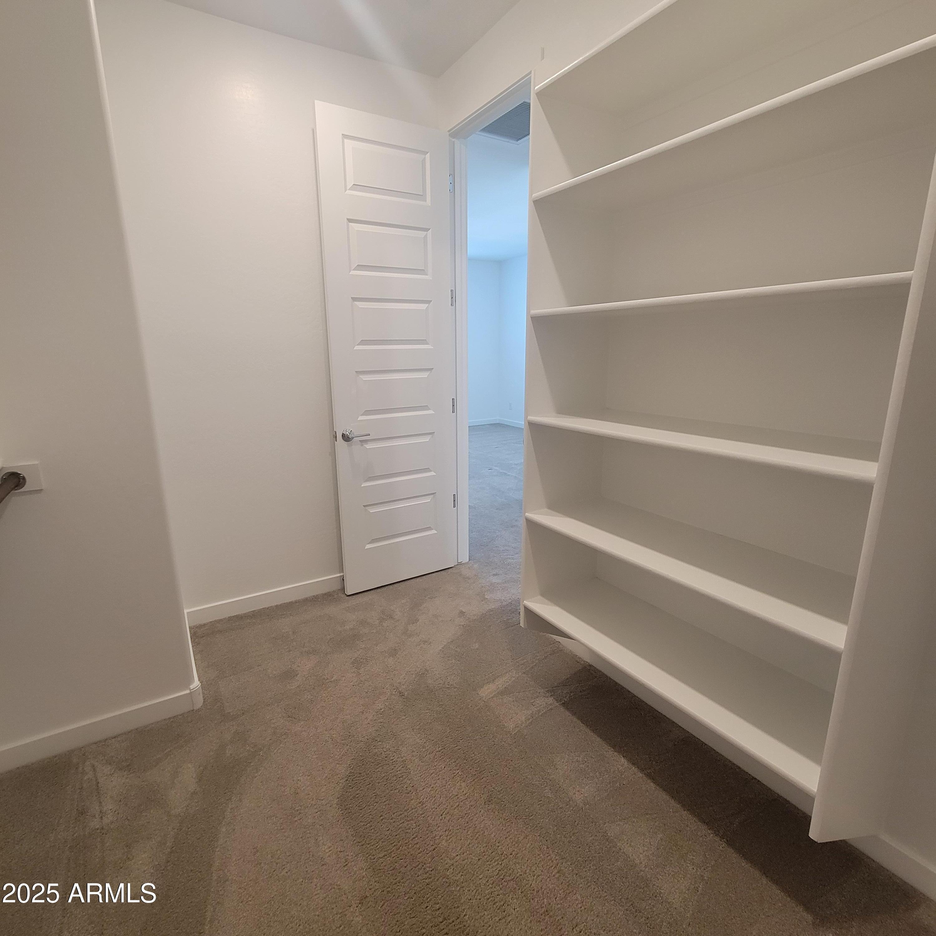 4077 South Sabrina Drive, Unit 30 Chandler, AZ 85248 - Photo 26 of 37 a view of walk in closet with empty racks