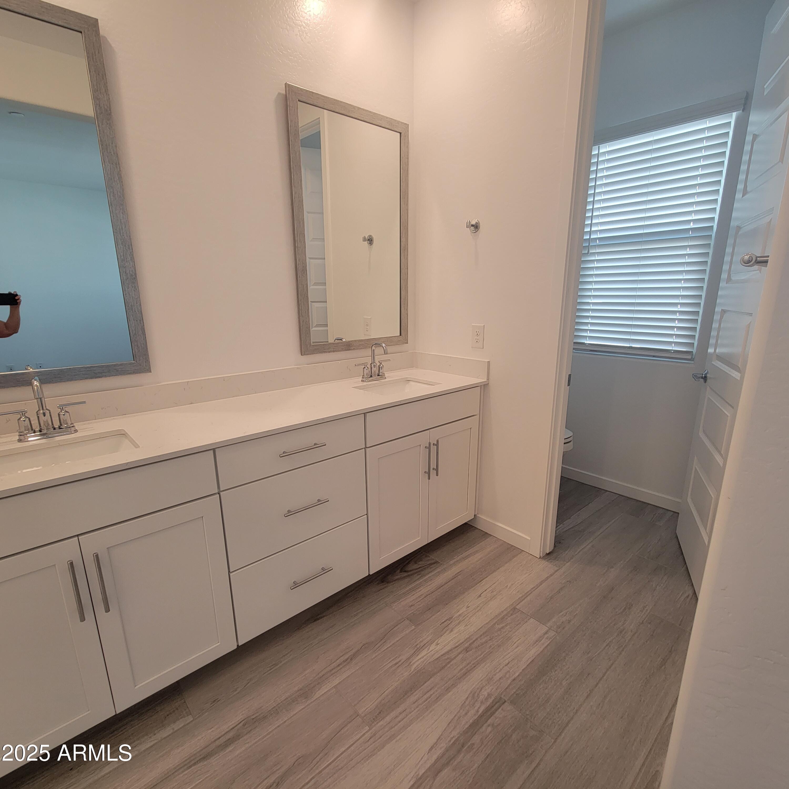 4077 South Sabrina Drive, Unit 30 Chandler, AZ 85248 - Photo 29 of 37 a spacious bathroom with a double vanity sink and mirror