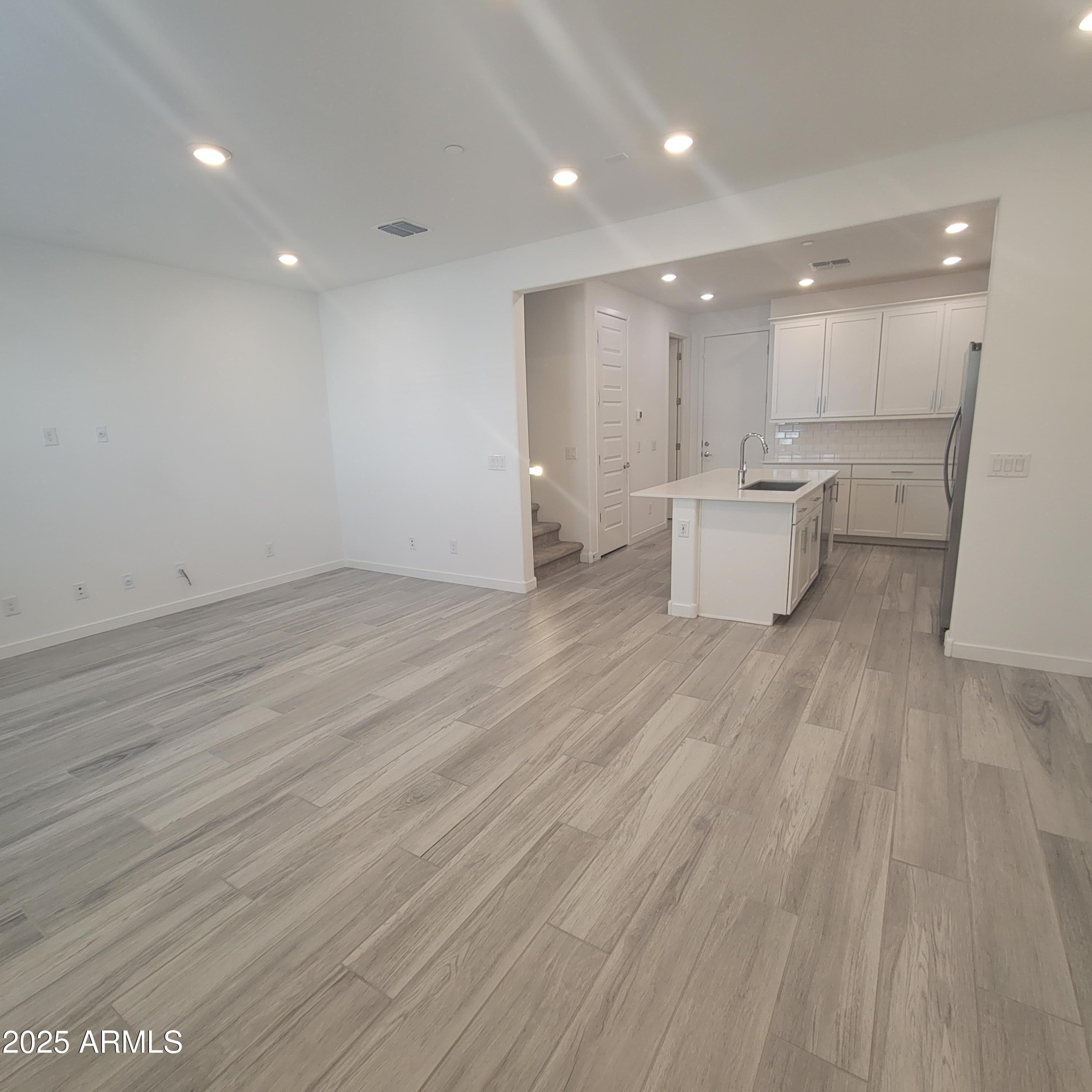 4077 South Sabrina Drive, Unit 30 Chandler, AZ 85248 - Photo 3 of 37 a view of a kitchen with a sink and a refrigerator