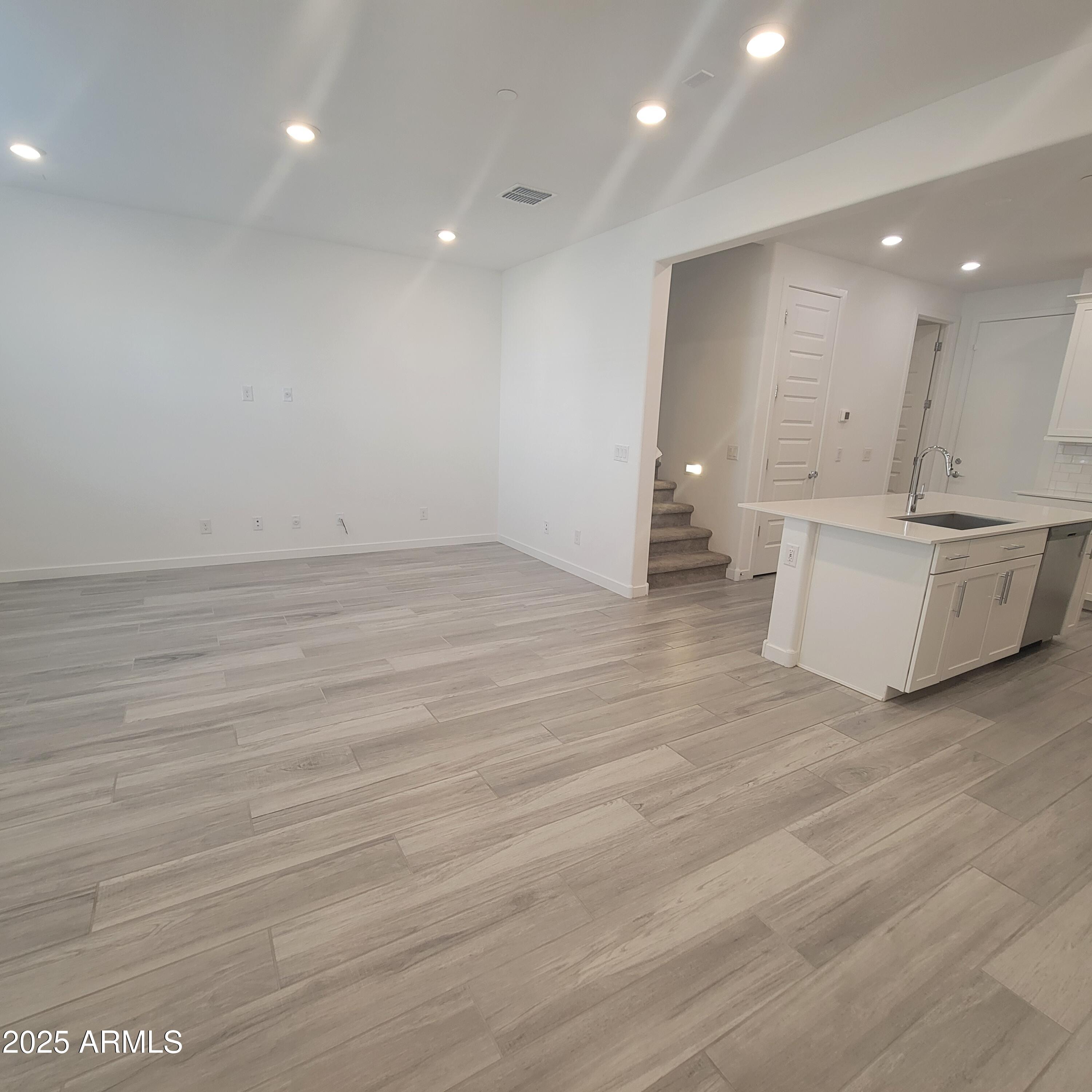 4077 South Sabrina Drive, Unit 30 Chandler, AZ 85248 - Photo 4 of 37 a view of an empty room with wooden floor and a window
