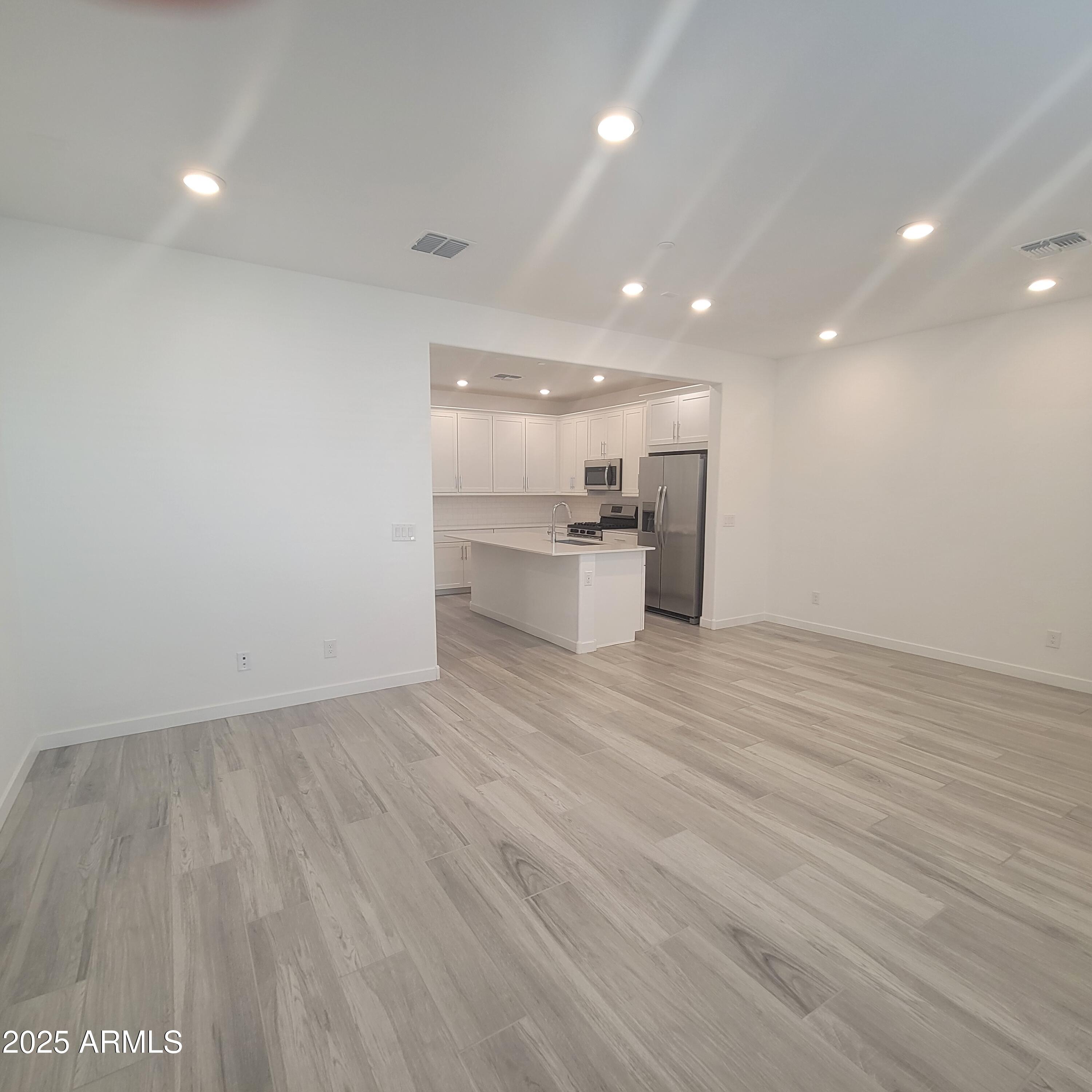4077 South Sabrina Drive, Unit 30 Chandler, AZ 85248 - Photo 5 of 37 a view of a kitchen with a sink and a refrigerator