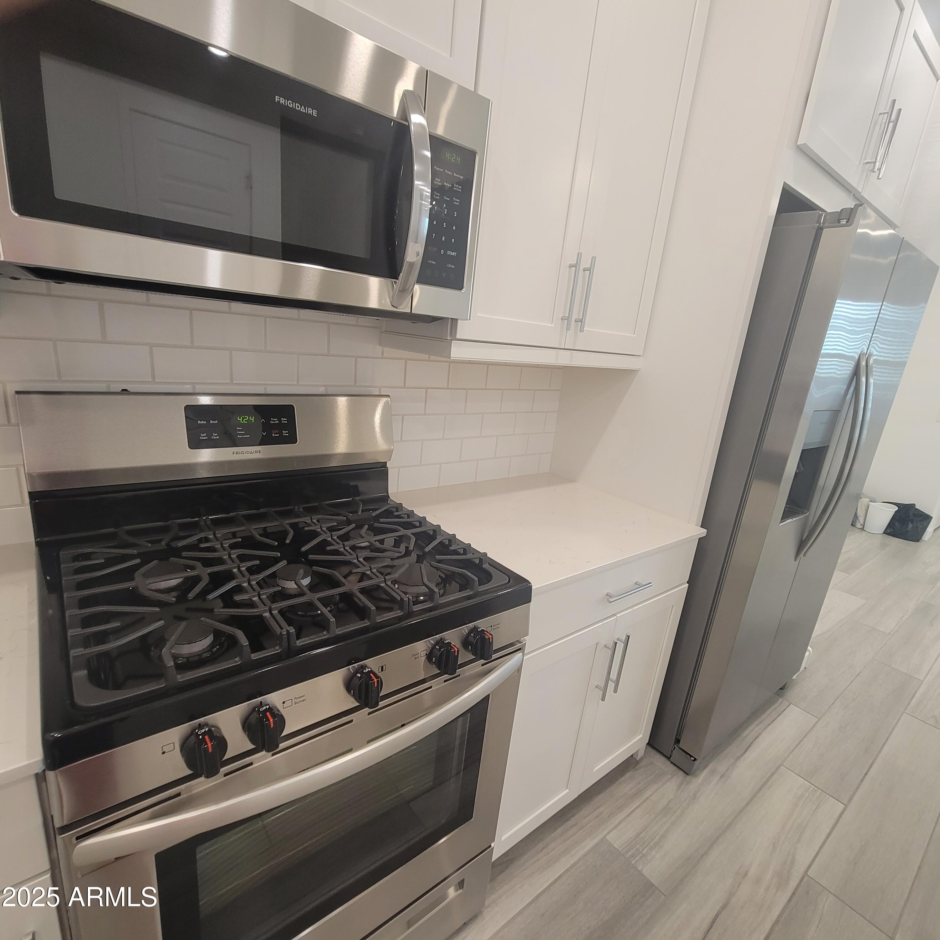 4077 South Sabrina Drive, Unit 30 Chandler, AZ 85248 - Photo 7 of 37 a stove top oven sitting inside of a kitchen