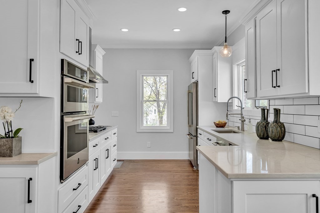 6 Regent Road Belmont, MA 02478 - Photo 12 of 29 a kitchen with stainless steel appliances a sink a stove and refrigerator