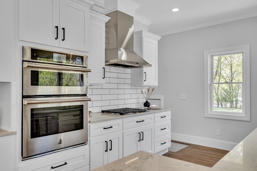 6 Regent Road Belmont, MA 02478 - Photo 14 of 29 a kitchen with granite countertop white cabinets stainless steel appliances and a sink