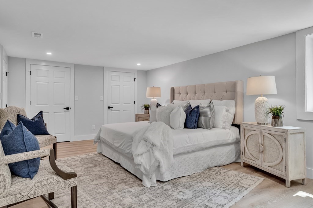 6 Regent Road Belmont, MA 02478 - Photo 16 of 29 a spacious bedroom with a bed a couch and a dresser