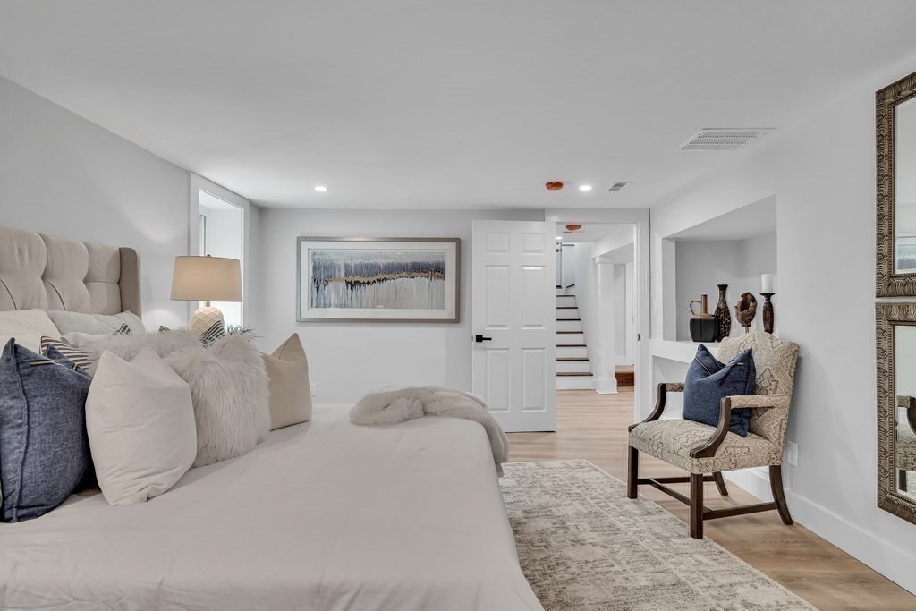 6 Regent Road Belmont, MA 02478 - Photo 17 of 29 a bedroom with furniture and a lamp