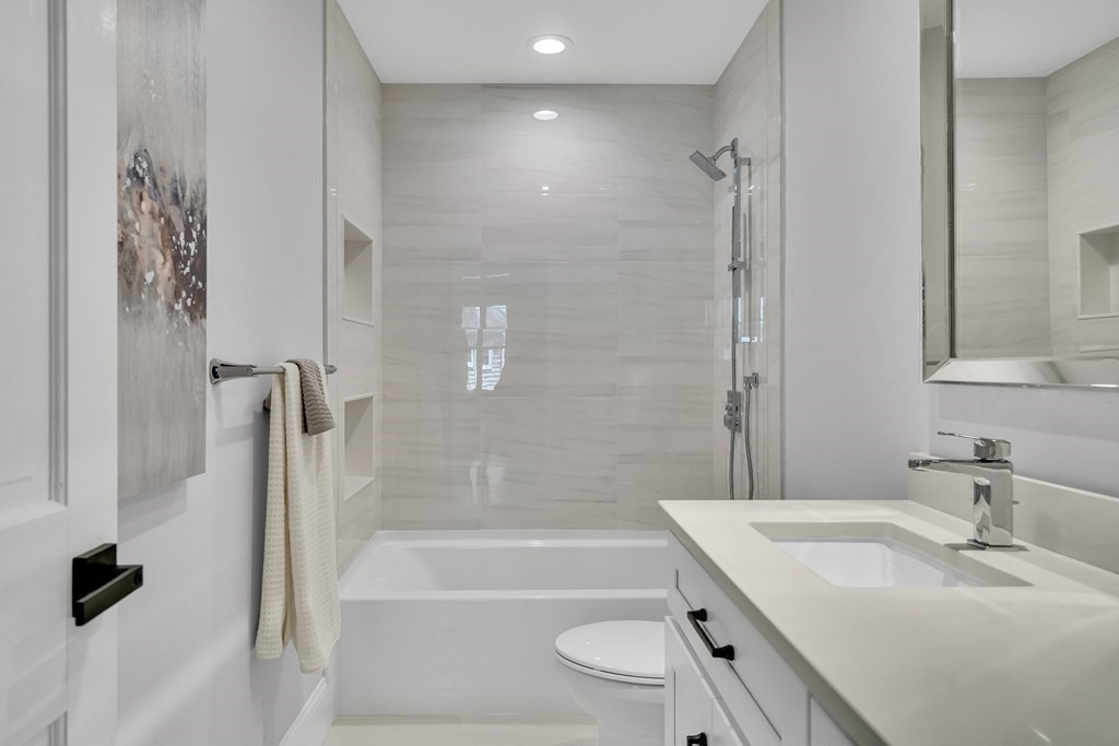 6 Regent Road Belmont, MA 02478 - Photo 21 of 29 a bathroom with a tub sink toilet and a mirror