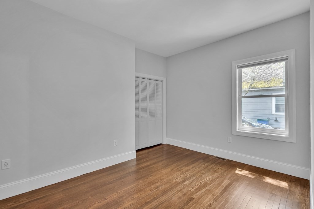 6 Regent Road Belmont, MA 02478 - Photo 23 of 29 a view of an empty room with wooden floor and a window