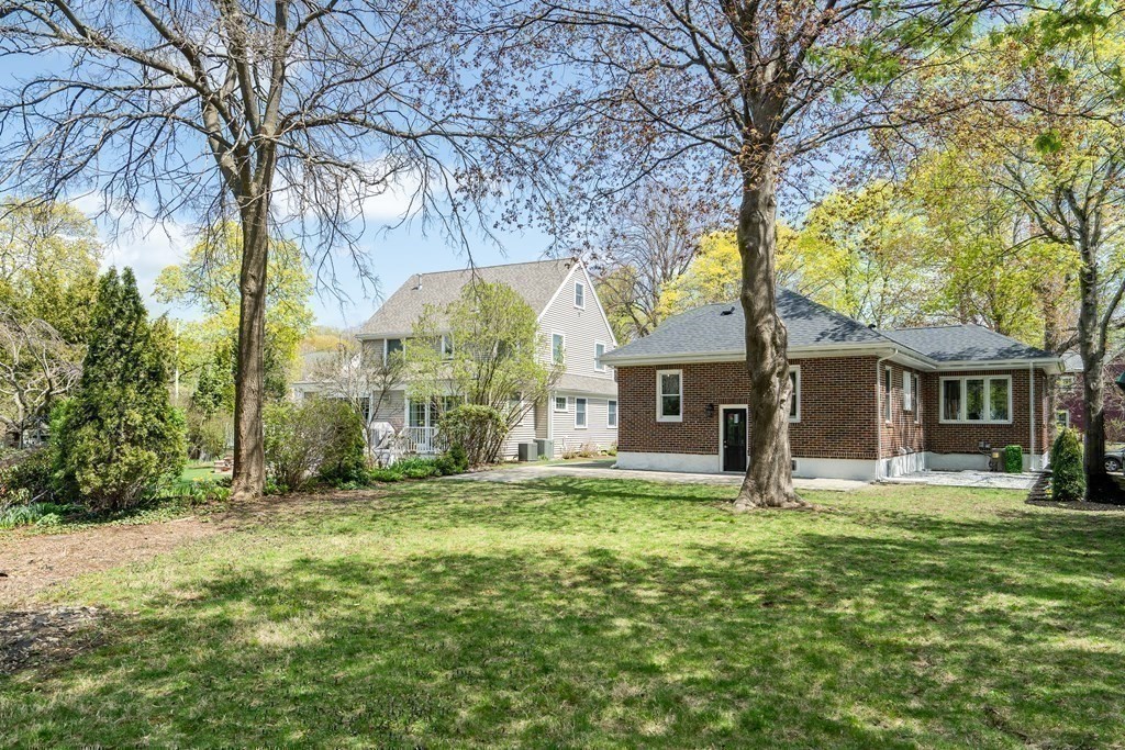 6 Regent Road Belmont, MA 02478 - Photo 28 of 29 a yellow house in middle of the forest