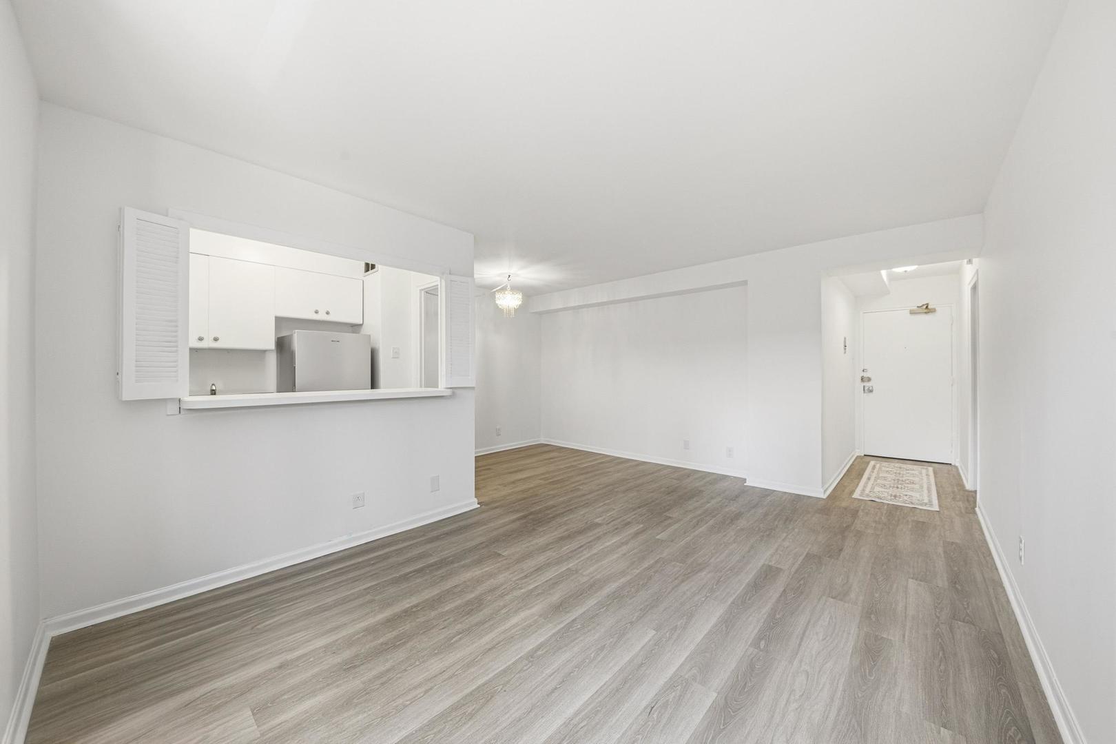 6118 North Sheridan Road, Unit 506 Chicago, IL 60660 - Photo 7 of 13 a view of kitchen and empty room with wooden floor