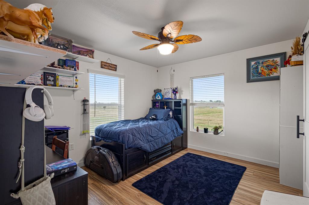 124 County Road 4511 Decatur, TX 76234 - Photo 24 of 39 a bedroom with a bed and a chandelier