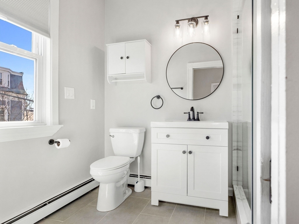 58 Telegraph Street, Unit 2 Boston, MA 02127 - Photo 11 of 17 a bathroom with a toilet sink and mirror