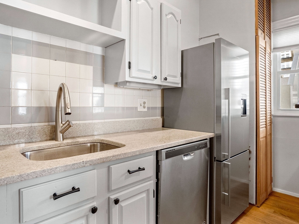58 Telegraph Street, Unit 2 Boston, MA 02127 - Photo 6 of 17 a kitchen with stainless steel appliances granite countertop a refrigerator and a sink