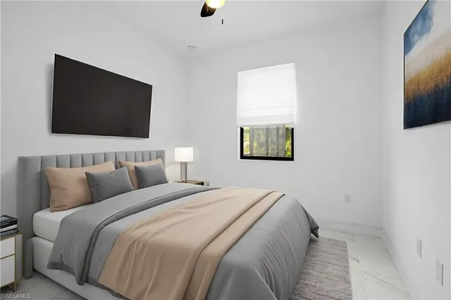 a bedroom with a large bed and a flat screen tv