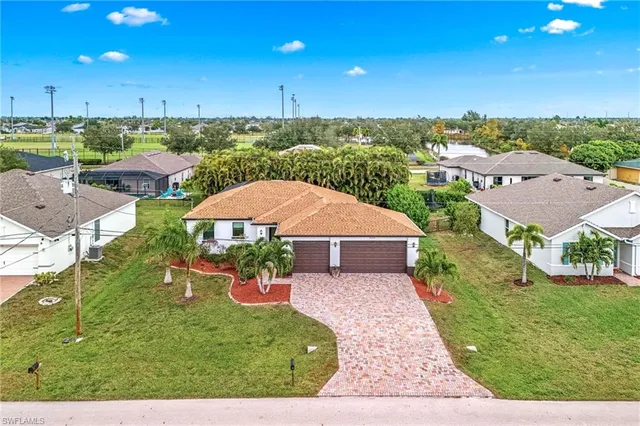 an aerial view of a house with garden space and street view