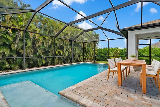 a view of yard with a table and chairs under an umbrella