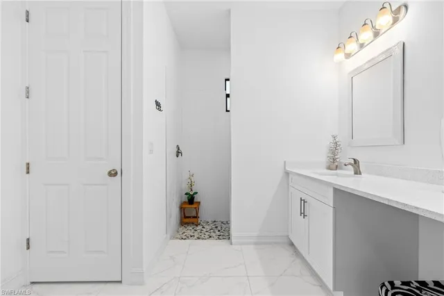 a spacious bathroom with a sink and a mirror