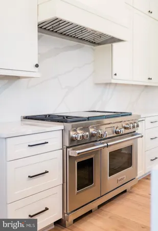 a stove top oven sitting inside of a kitchen