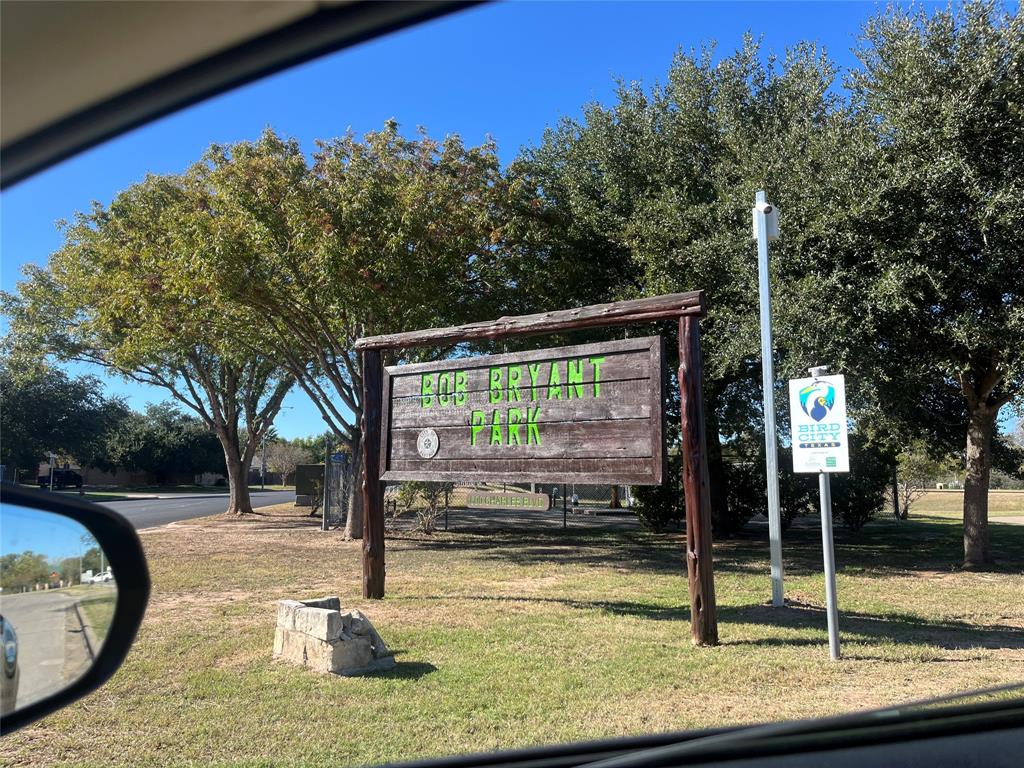 617 Barbara Way Bastrop, TX 78602 - Photo 19 of 20 A rustic wooden sign welcomes visitors to a verdant park, promising serene outdoor enjoyment.