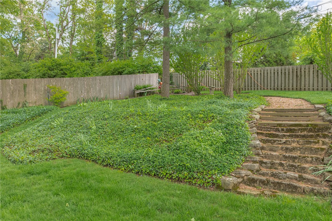 156 West Hadley Road Dayton, OH 45419 - Photo 54 of 71 This tranquil backyard offers a natural stone staircase and lush greenery.