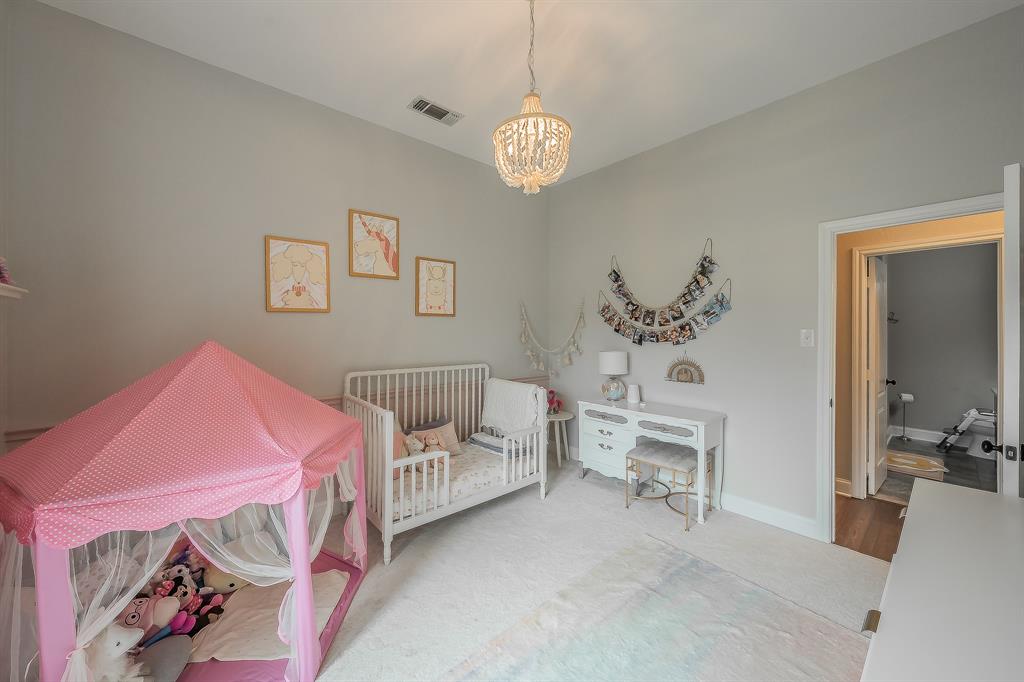 115 Pheasant Run Road Argyle, TX 76226 - Photo 25 of 40 a bedroom with a bed and a chandelier