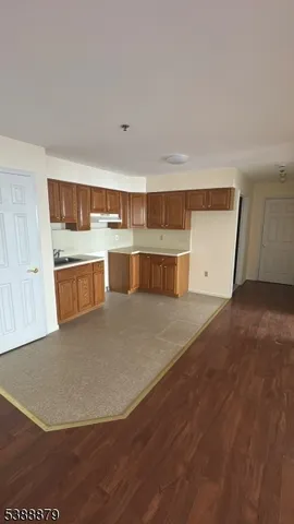 a view of kitchen and empty room