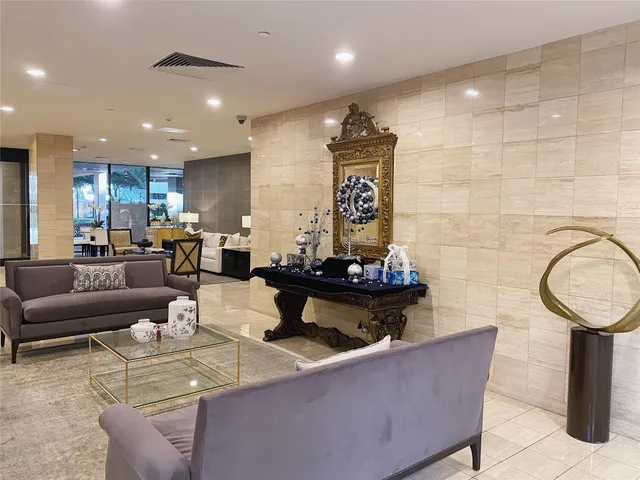 a living room with furniture and a mirror