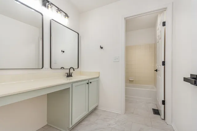 a bathroom with a double vanity sink mirror and