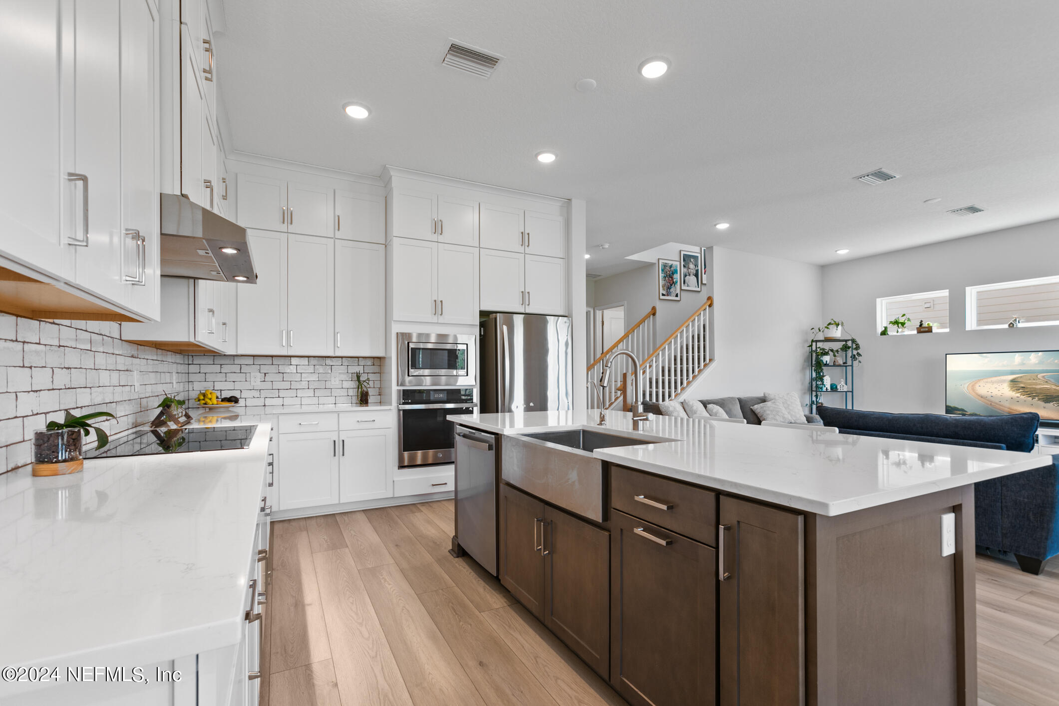 10020 Invention Lane Jacksonville, FL 32256 - Photo 13 of 87 a kitchen with counter top space a sink stainless steel appliances and cabinets