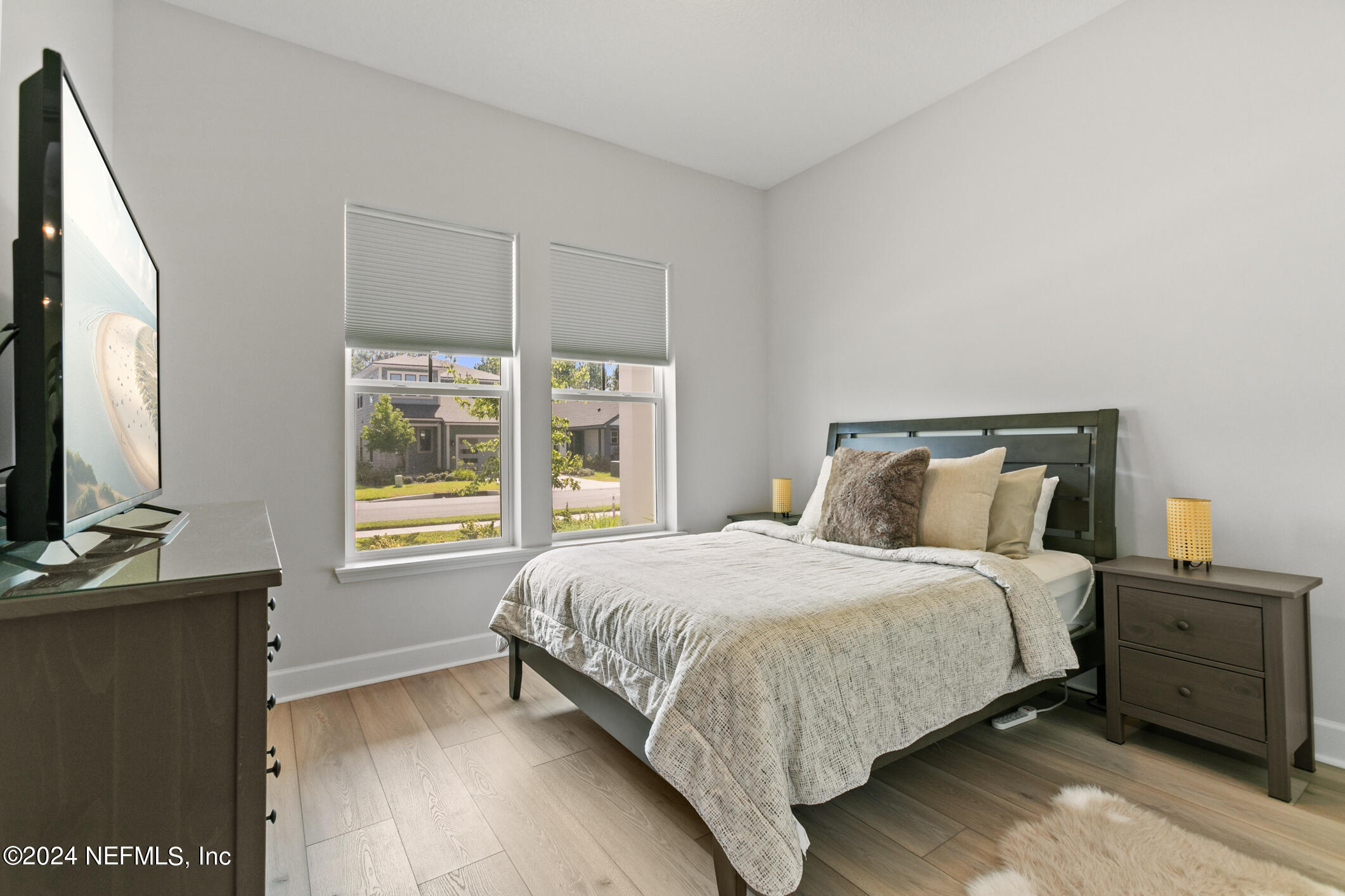 10020 Invention Lane Jacksonville, FL 32256 - Photo 24 of 87 a bedroom with a bed and a flat tv screen on dresser